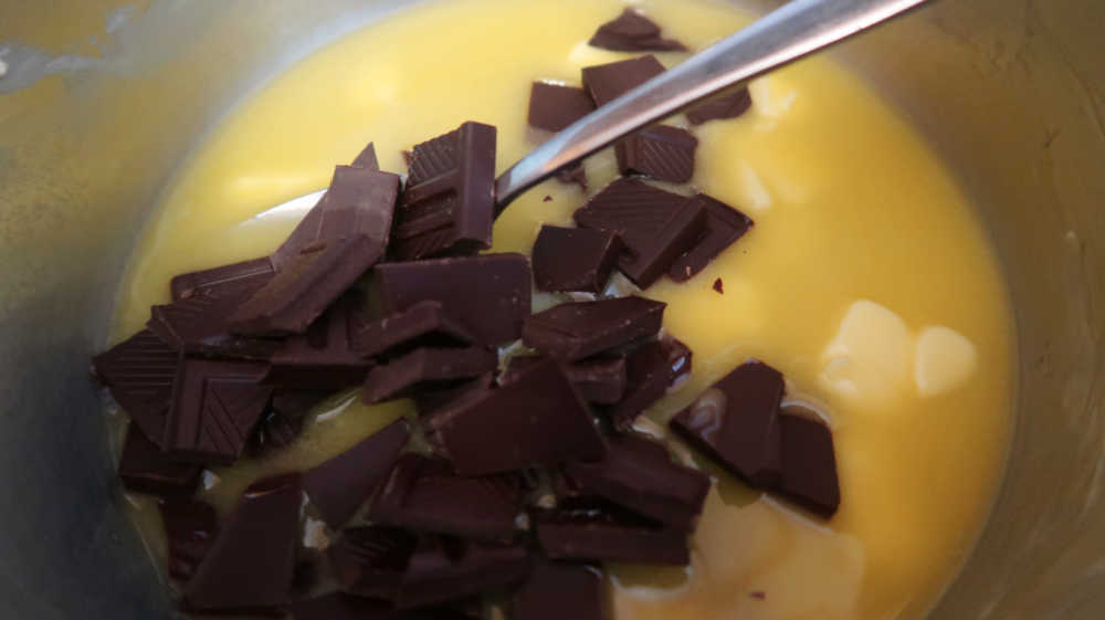 Adding chopped chocolate to the melted butter