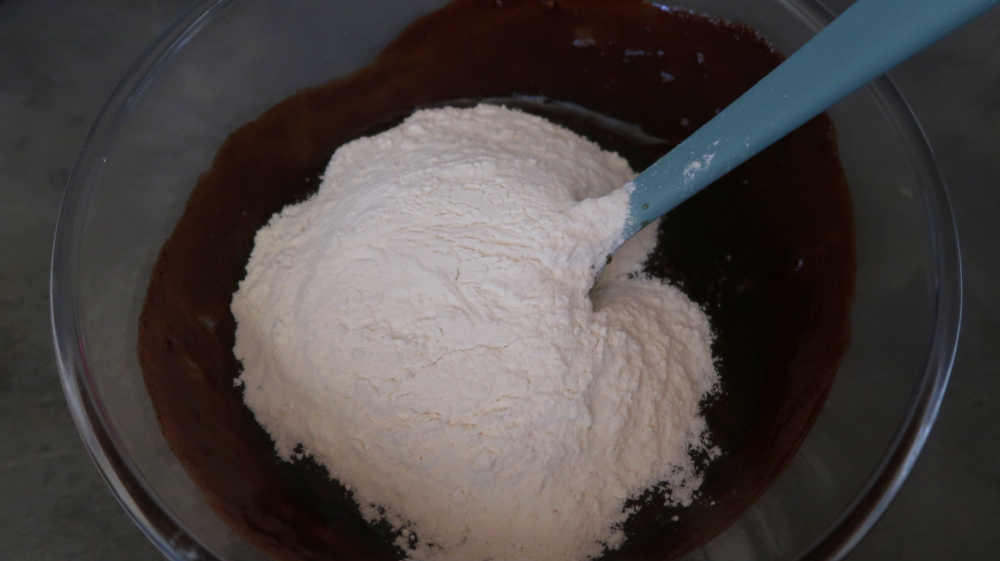 Adding flour to the chocolate banana brownie batter