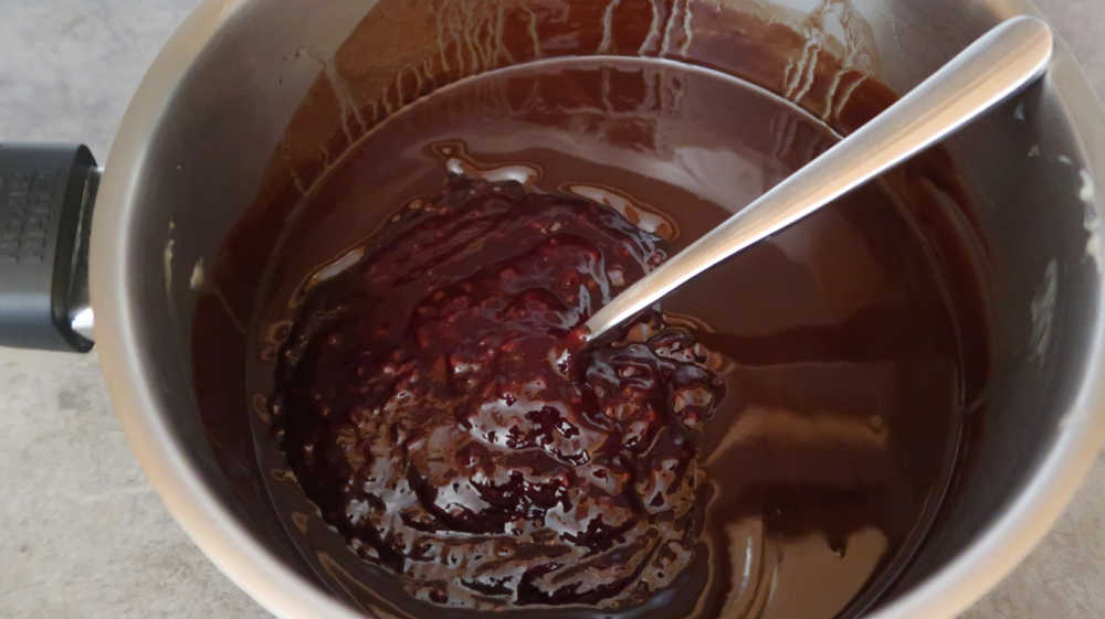 Mixing raspberry jam into the chocolate cupcake batter