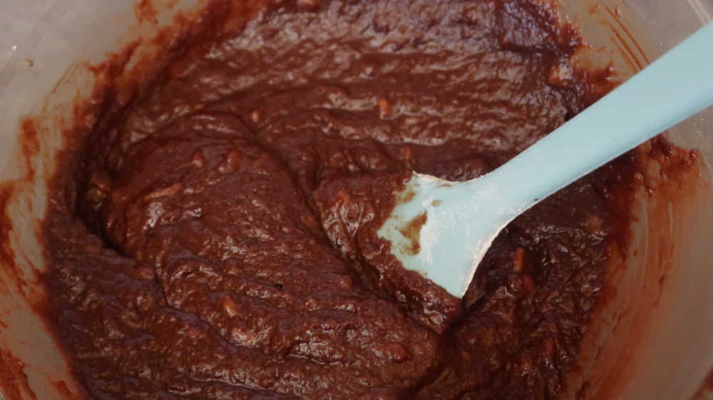 Mixing the simple ingredients together to form the banana chocolate brownie batter