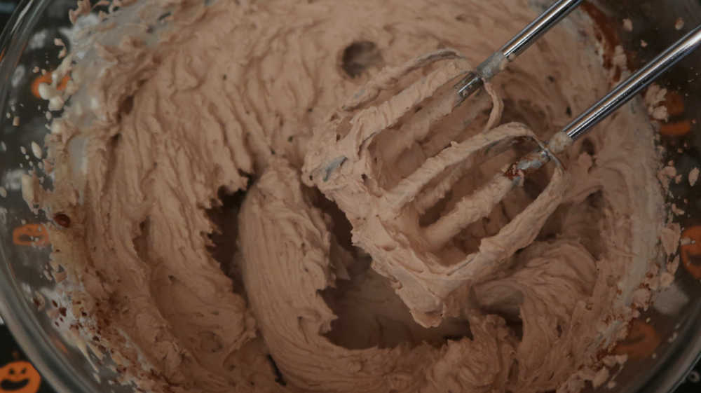 Whisking the ingredients together to form a chocolate mousse