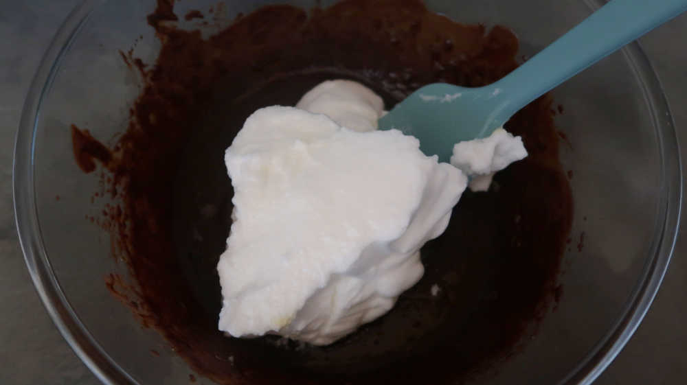 Folding the whipped eggs whites into the chocolate mixture